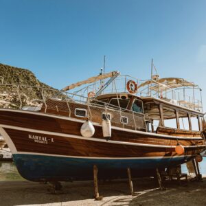 A vibrant scene of rustic wooden boats docked by a sunny coastline, ideal for travel and leisure themes.
